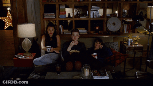 Group Sitting On Couch Eating Popcorn GIF