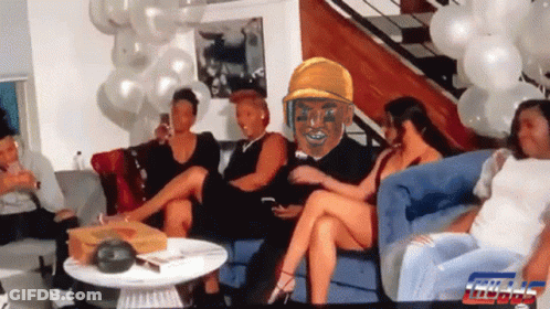 Group Sitting On Couch With Balloons And Man In Yellow Hat GIF