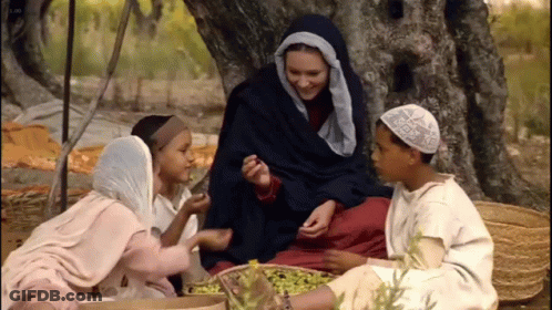 Group Sitting Under Tree One With White Hat GIF