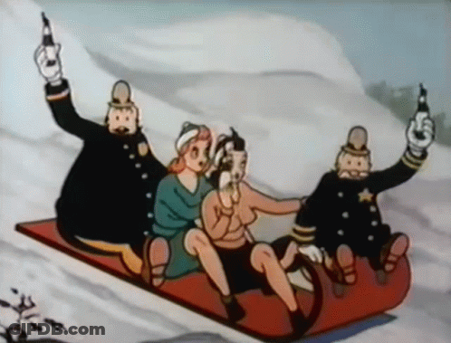 Group Sledding Down Snowy Hill With Police Officers Holding Guns GIF