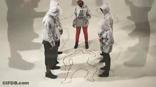 Group Standing Around Body Drawing With 17 And Injured Hoodie GIF