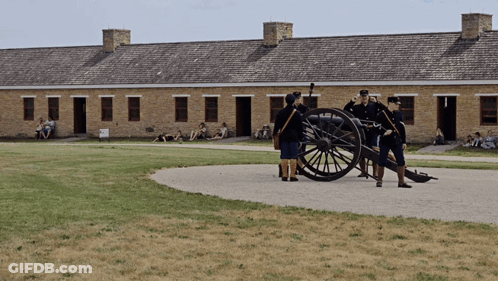 Group Standing Around Cannon GIF