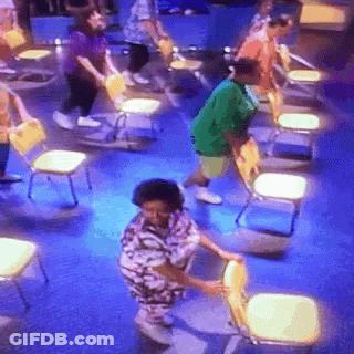 Group Standing Around Chairs On Blue Carpet GIF