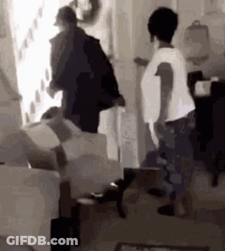 Group Standing Around Couch In Black And White GIF