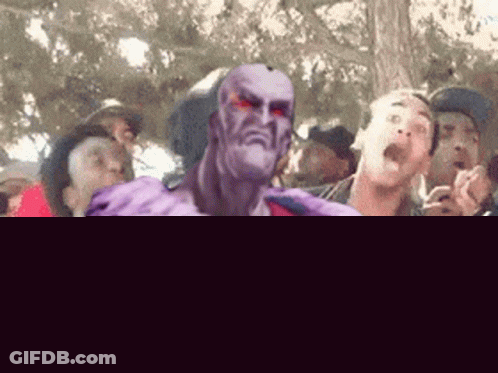 Group Standing Around Man In Purple Outfit GIF