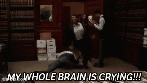 Group Standing Around Man Laying On Floor In Library GIF