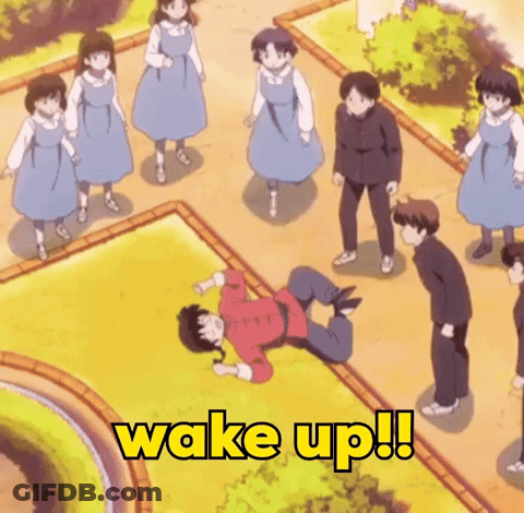 Group Standing Around Man Laying On Ground Saying Wake Up GIF
