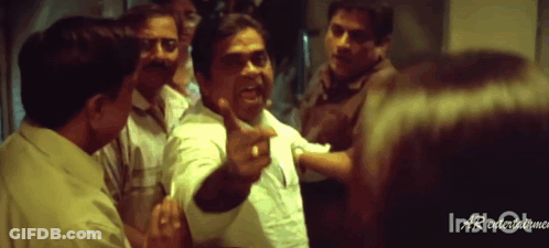 Group Standing Around Man Pointing GIF