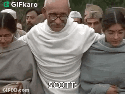 Group Standing Around Man With Mustache And Glasses GIF
