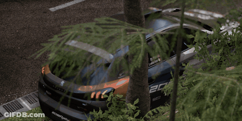 Group Standing Around Overturned Car GIF