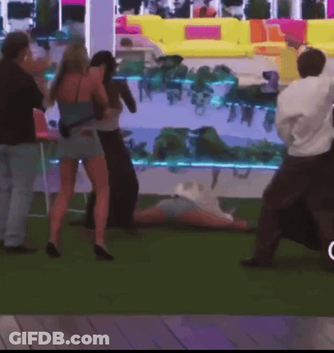 Group Standing Around Person Lying On Ground GIF