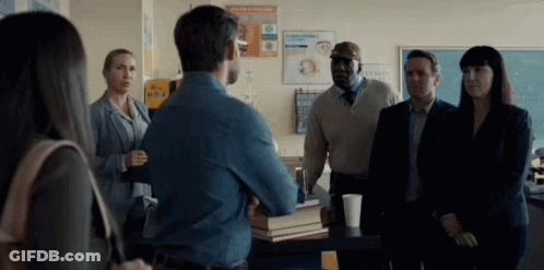 Group Standing Around Table GIF