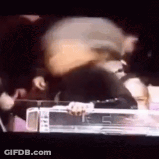 Group Standing Around Table In Dark Room GIF