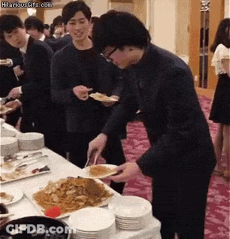 Group Standing Around Table With Hilariousgifs.com Sign GIF