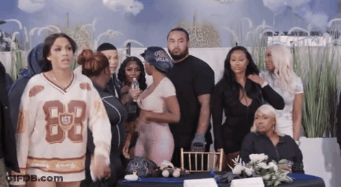 Group Standing Around Table With Jersey Number 83 GIF