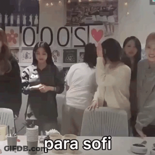 Group Standing Around Table With Para Sofi GIF