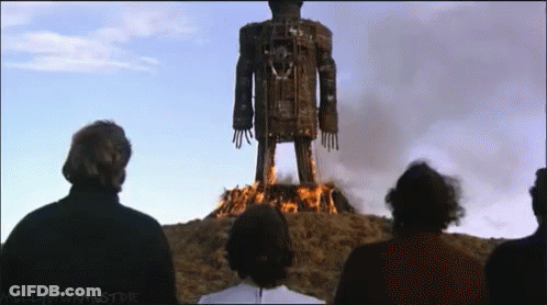 Group Standing Before Burning Statue Mulled Wine Must Die GIF