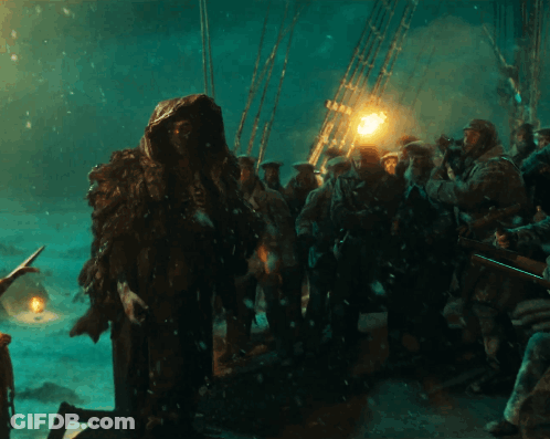 Group Standing In Dark Room With Lantern GIF