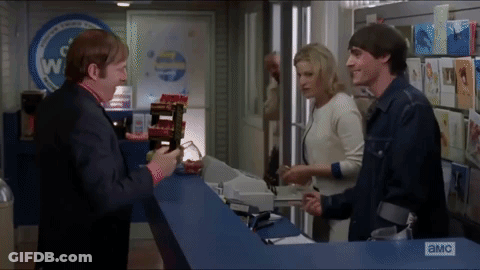 Group Standing In Front Of A & MC Sign GIF