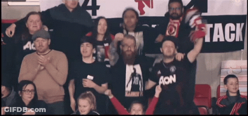 Group Standing In Front Of Banner Saying Tack GIF