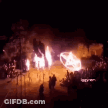 Group Standing In Front Of Burning Car GIF