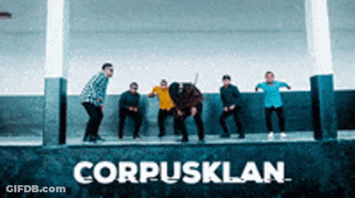 Group Standing In Front Of CorpusKlan Sign GIF