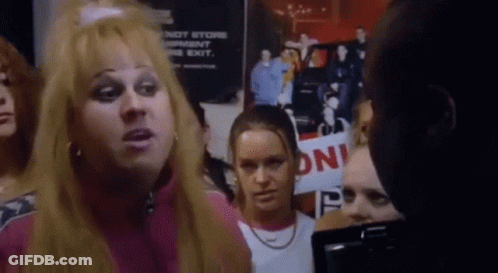 Group Standing In Front Of Do Not Store Garment On The Exit Sign GIF
