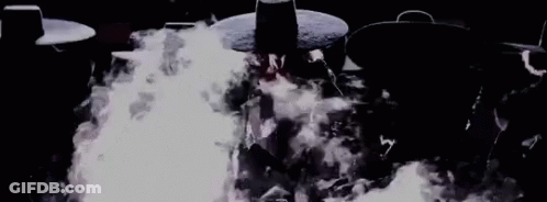 Group Standing In Front Of Fire GIF