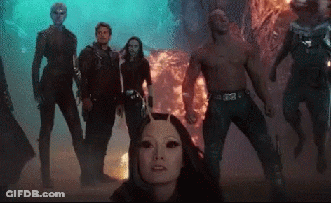 Group Standing In Front Of Fireball GIF