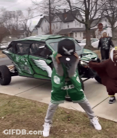 Group Standing In Front Of Green Vehicle GIF