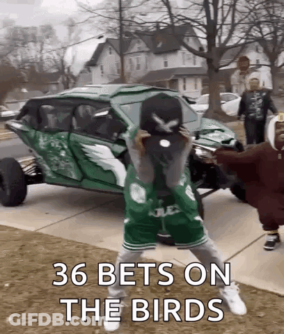 Group Standing In Front Of Green Vehicle GIF