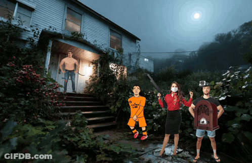 Group Standing In Front Of House With Man In CBS Shirt GIF