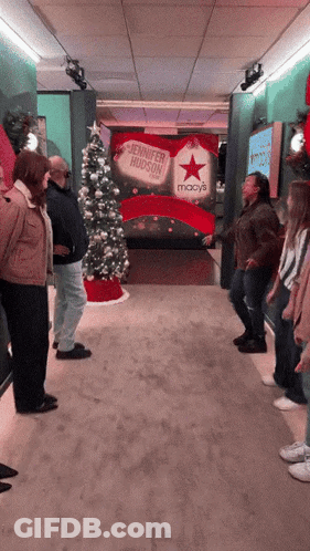 Group Standing In Front Of Jennifer Hudson Sign GIF