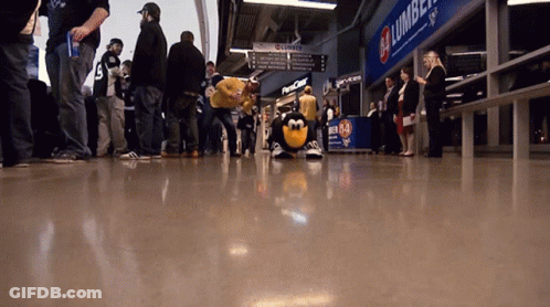 Group Standing In Front Of Lumber Sign GIF