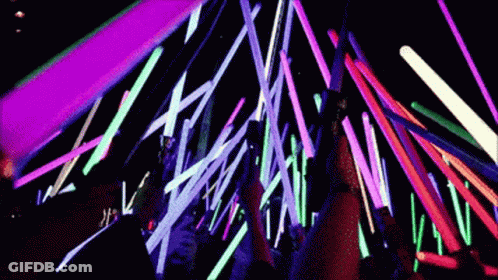 Group Standing In Front Of Neon Lights GIF