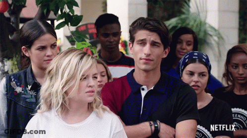 Group Standing In Front Of Netflix Sign GIF