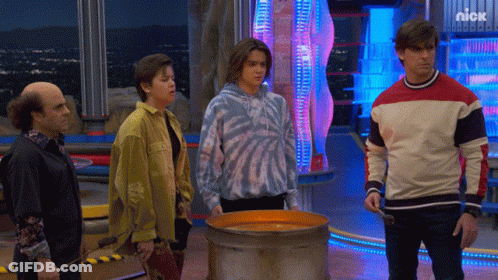 Group Standing In Front Of Nickelodeon Advertisement GIF