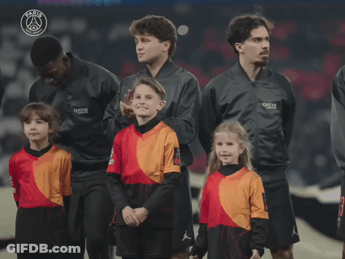 Group Standing In Front Of Paris Sign GIF