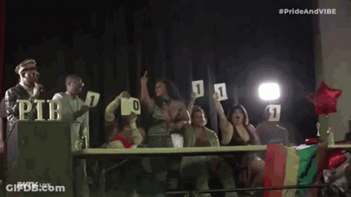 Group Standing In Front Of Pride And Vibe Sign GIF
