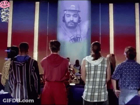 Group Standing In Front Of Screen With Man GIF