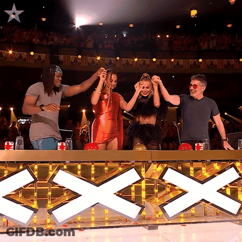 Group Standing In Front Of Sign Saying Xxx GIF