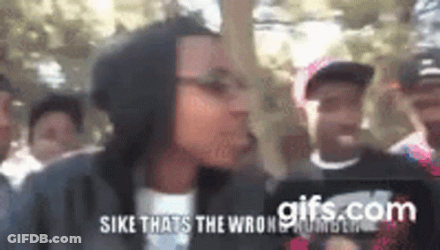 Group Standing In Front Of Sike Sign GIF