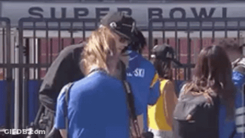 Group Standing In Front Of Super Bowl Sign GIF