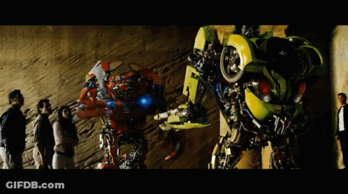 Group Standing In Front Of Transformer Number 4 GIF