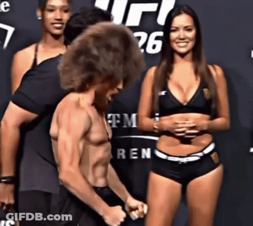 Group Standing In Front Of UFC 26 Sign GIF