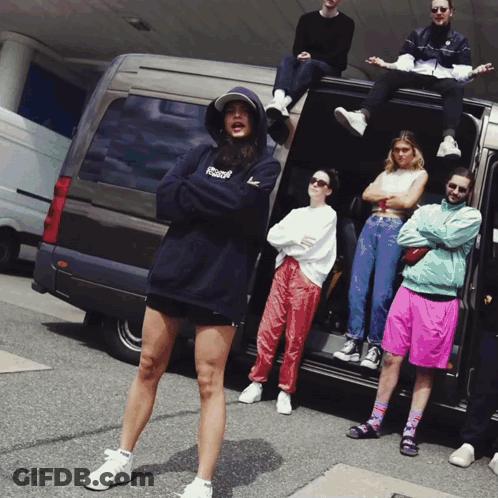 Group Standing In Front Of Van With Reebok Hoodie GIF