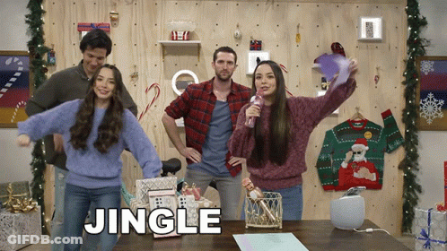 Group Standing In Front Of Wall Saying Jingle GIF