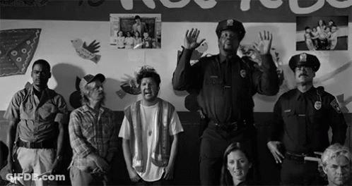 Group Standing In Front Of Wall With Pictures GIF