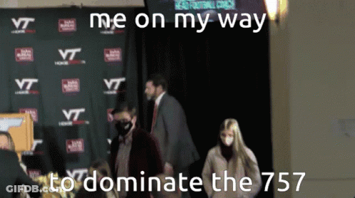 Group Standing In Front Of Wall With VT Logos GIF