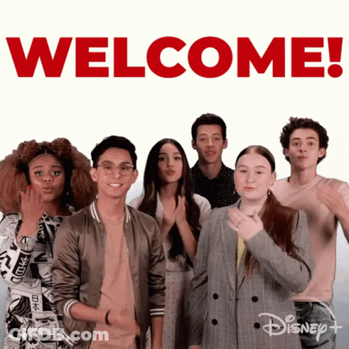 Group Standing In Front Of Welcome Sign GIF